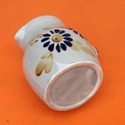 Glazed ceramic pitcher floral decoration