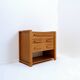 1960s wooden sewing cabinet with double-sided drawers
