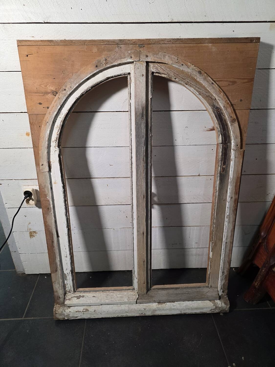 Old arched window made of fir wood