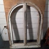 Old arched window made of fir wood