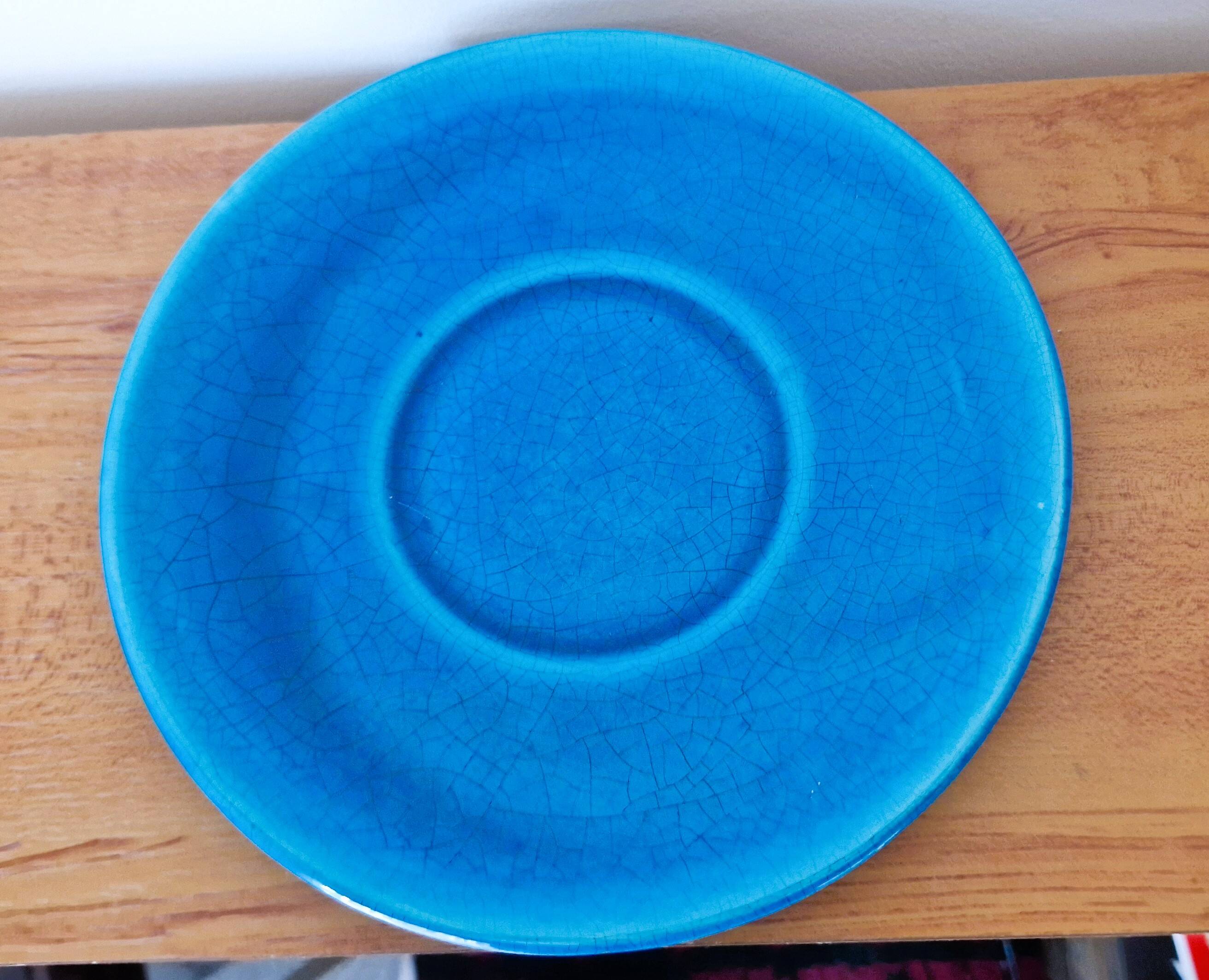 Blue ceramic soup tureen and crackled finish trivet.