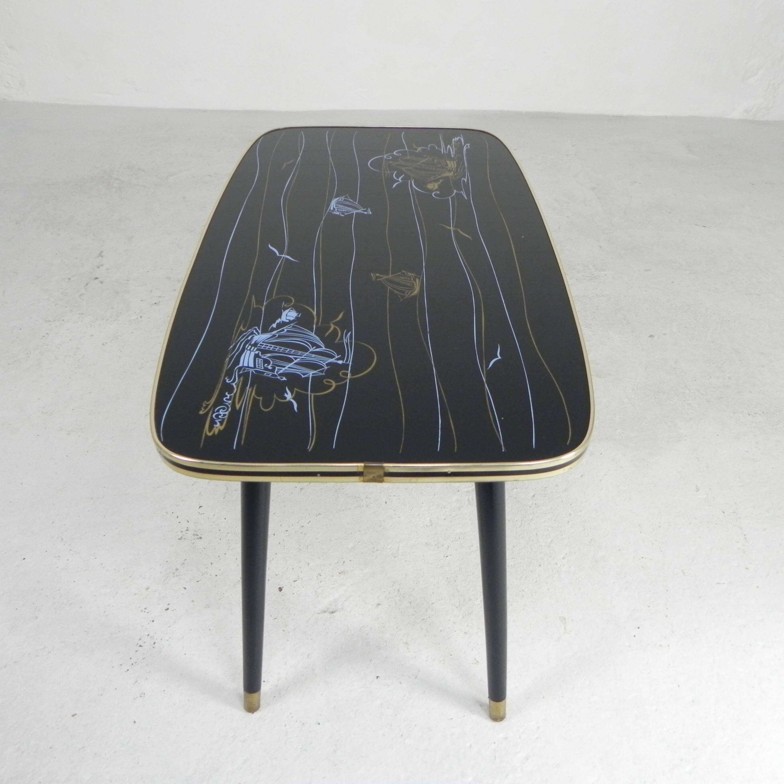 Vintage coffee table with glass top and angled legs