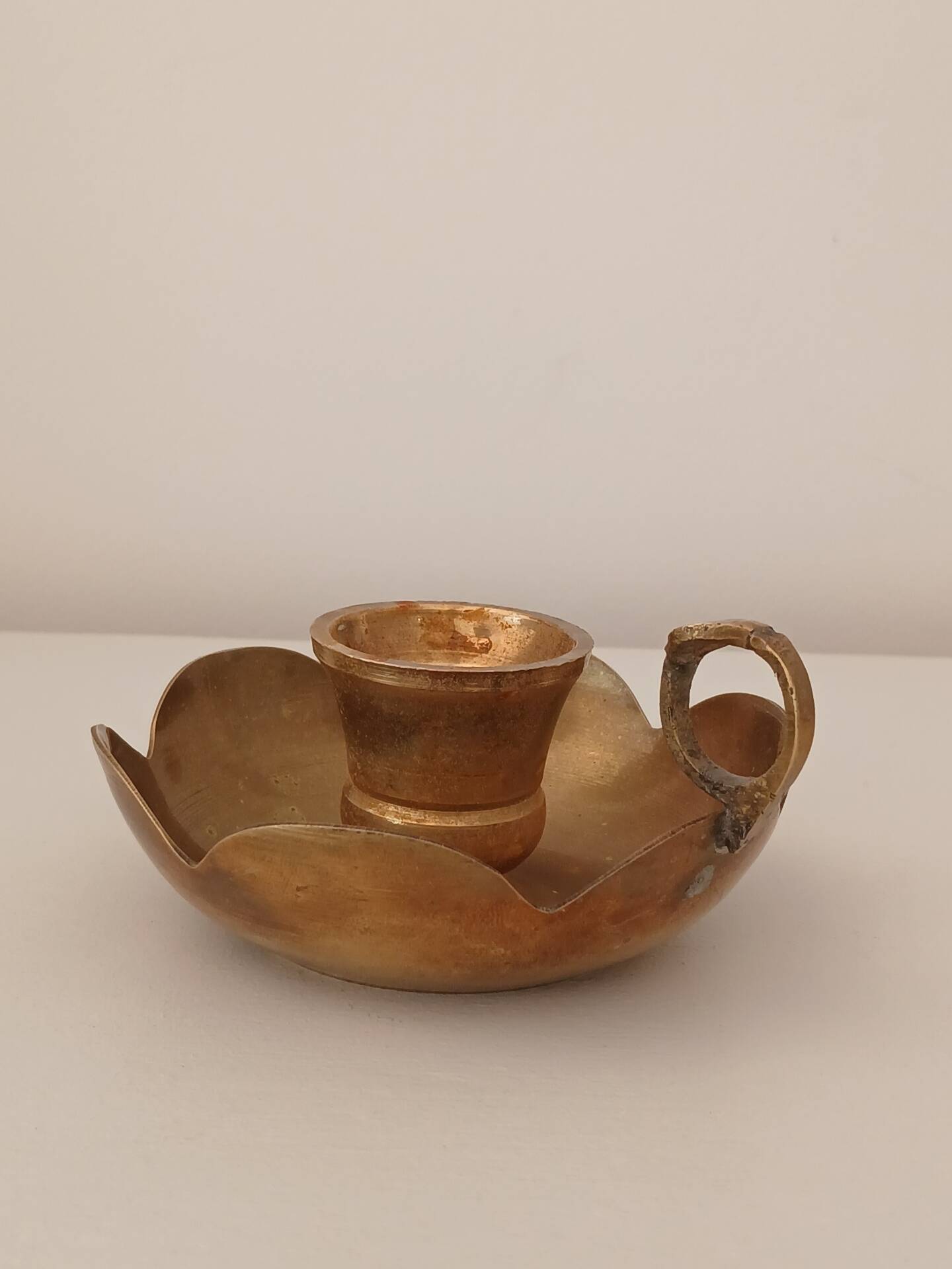 Brass candle holder in the shape of a flower.