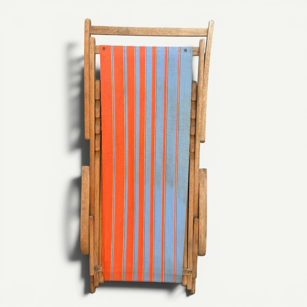Vintage deck chair with orange and blue striped fabric, original patina.