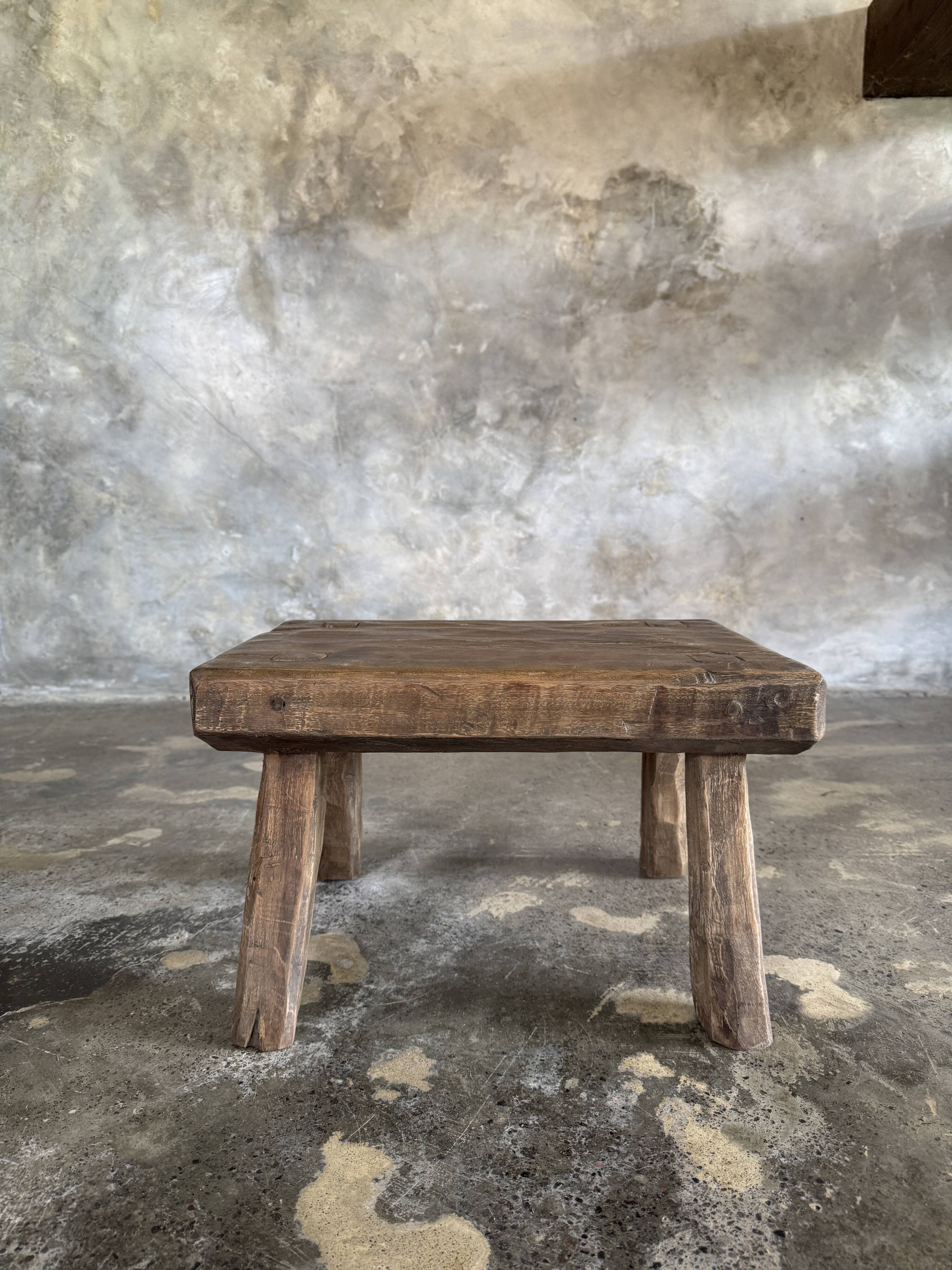 Small stool, rectangular solid teak side table with curved legs.