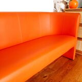 Curved vintage orange canapé with a pop spirit, seventies design piece.