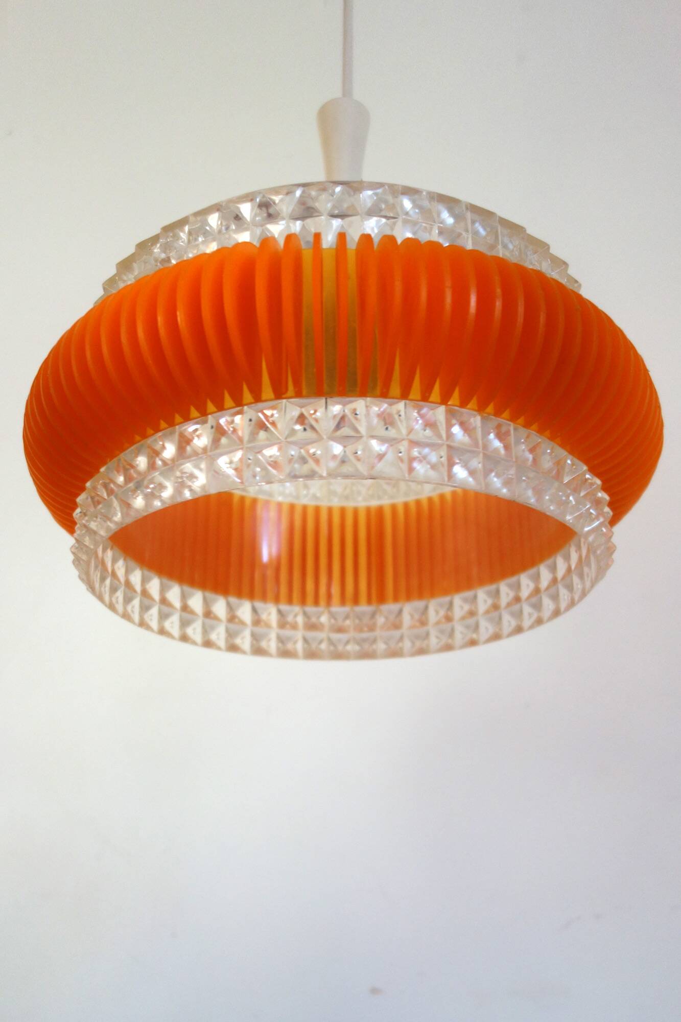 Transparent plastic space age lustre with orange band from the 70s.