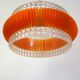 Transparent plastic space age lustre with orange band from the 70s.