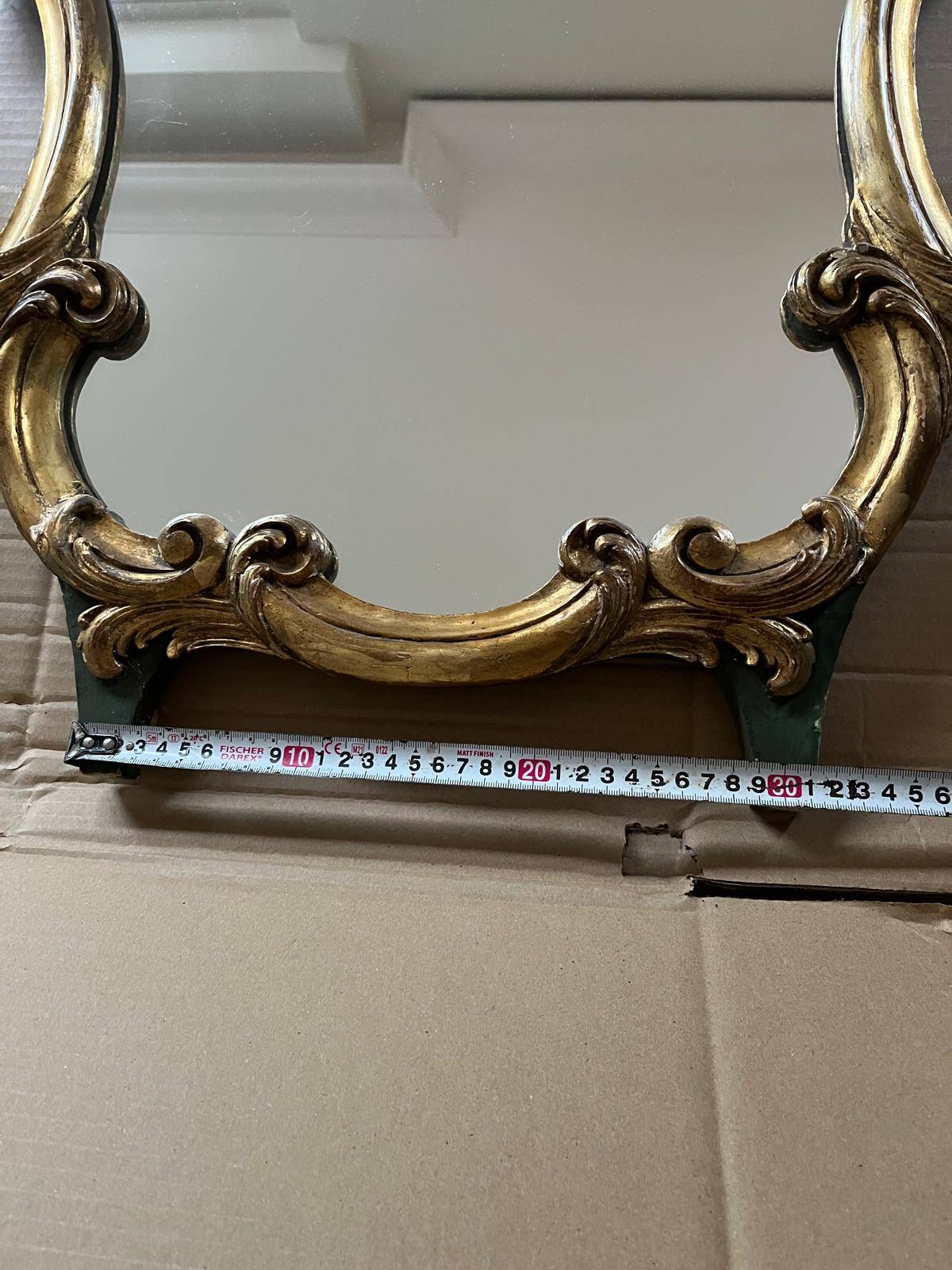 Large wall mirror with a gilded brass frame in Louis XV style.