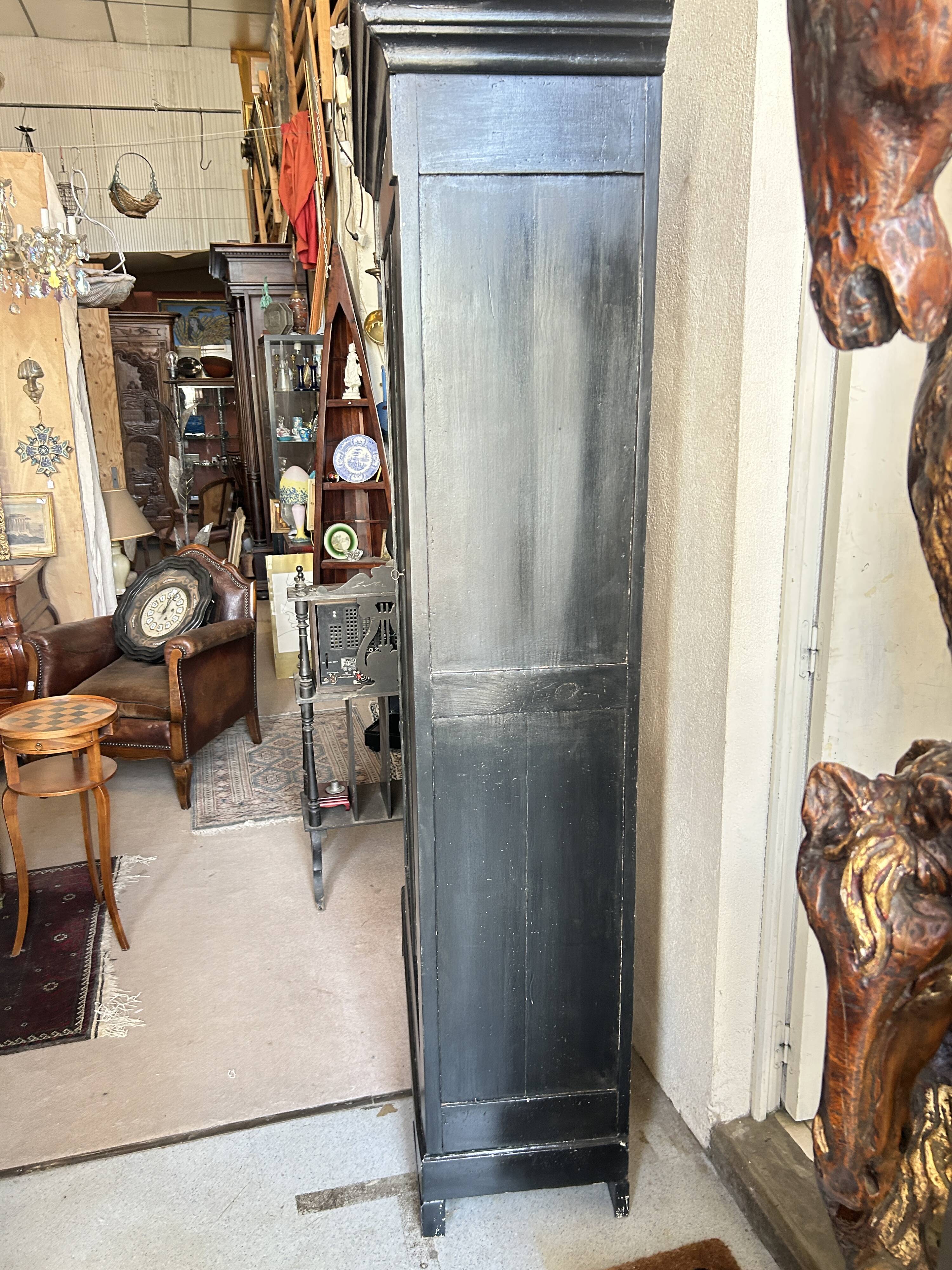 Black painted wardrobe with two glass doors and an interior sideboard.