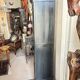 Black painted wardrobe with two glass doors and an interior sideboard.