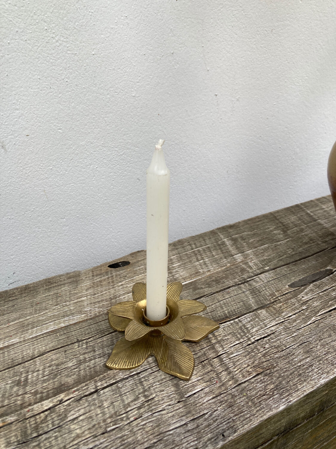 Old golden brass candle holder in the shape of a leaf or flower