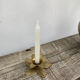 Old golden brass candle holder in the shape of a leaf or flower