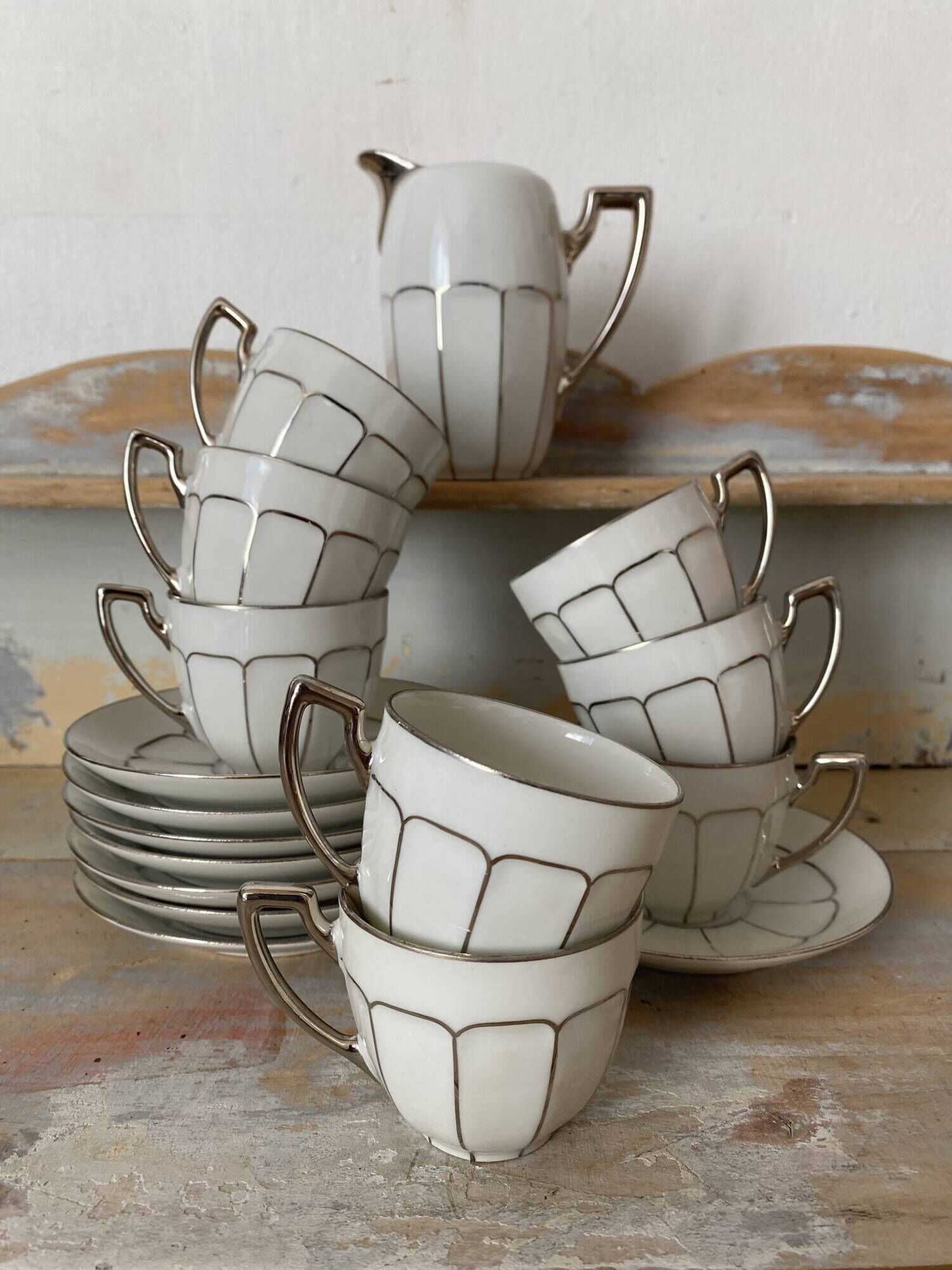 White and silver Limoges porcelain coffee cups and saucers.