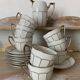 White and silver Limoges porcelain coffee cups and saucers.