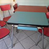Table in red formica, 4 roc chairs, 2 extension cords, 2 drawers 60