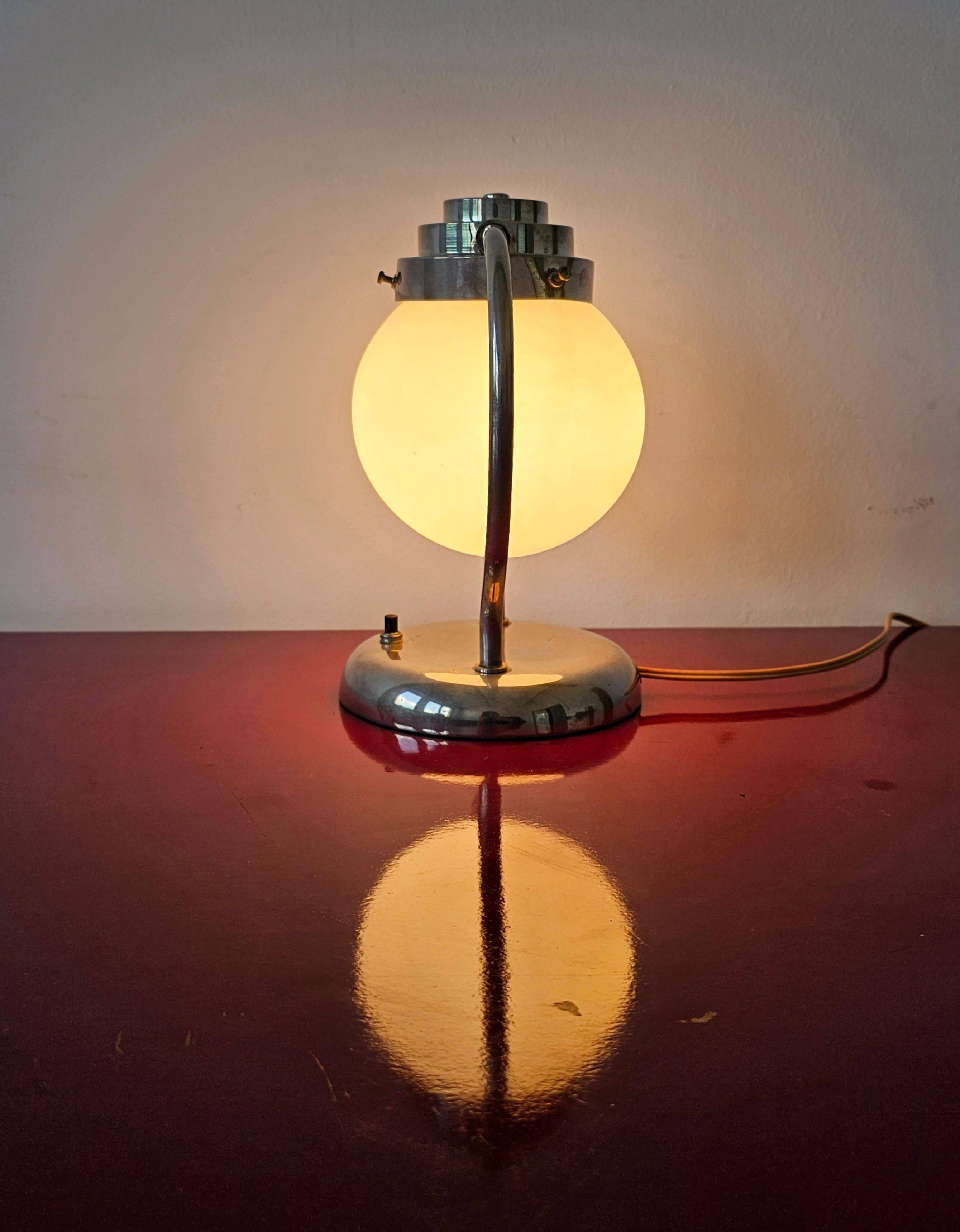 Art Deco table lamp with a spherical opaline glass shade and chrome base from the 1930s.