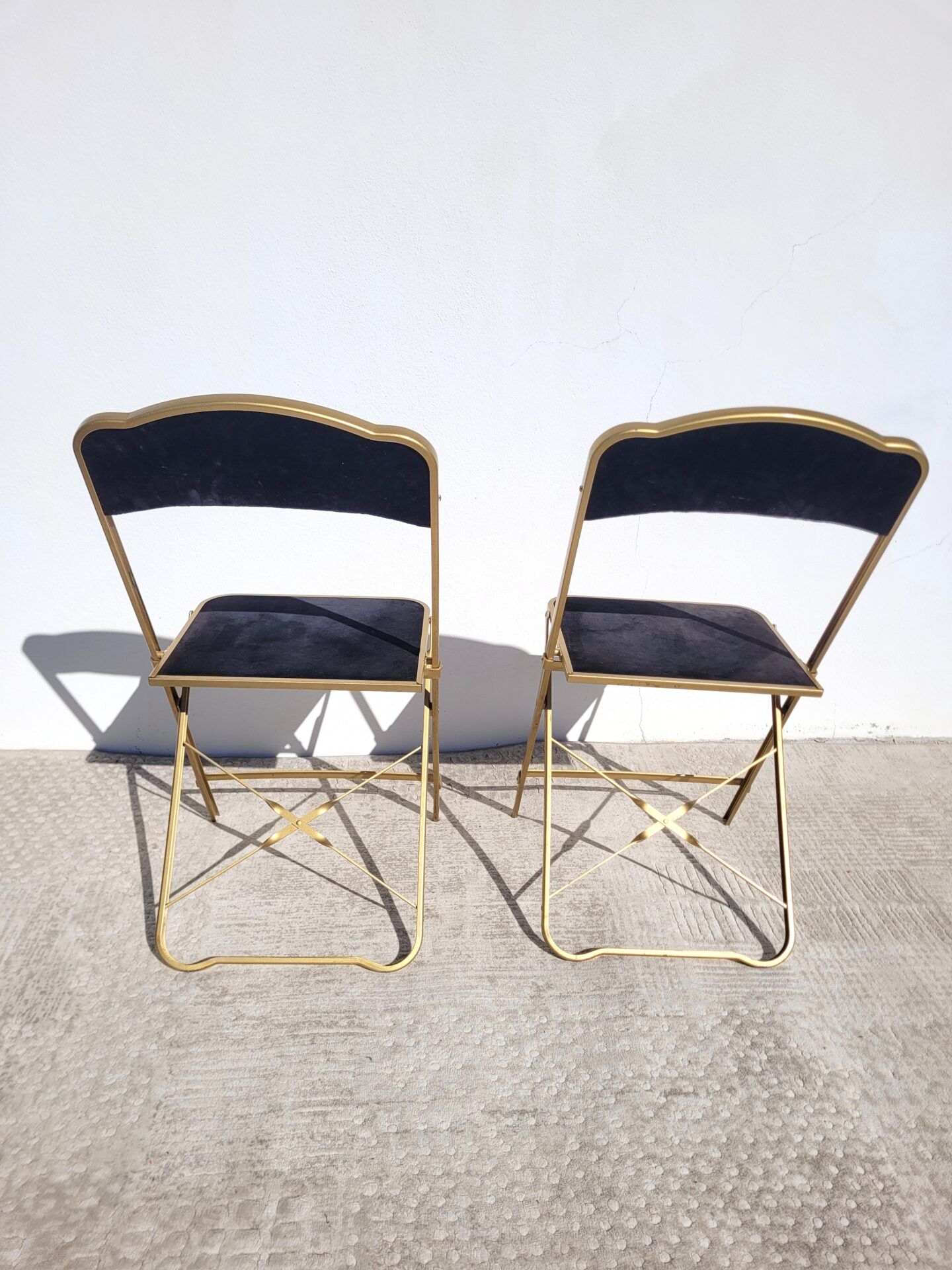 Pair of black and gold folding opera chairs