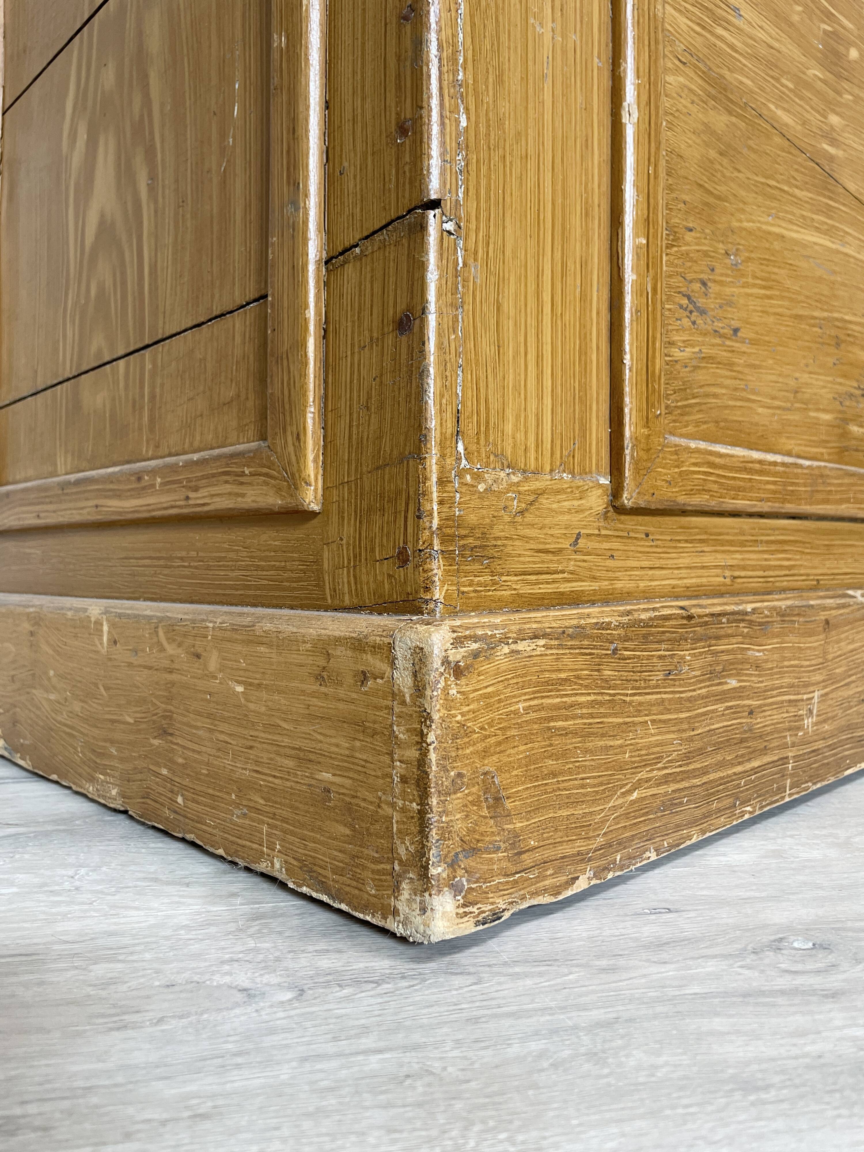 Wooden hardware cabinet painted with wood effect, circa 1940.