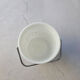 Vintage white opaline ice bucket with red patterns.