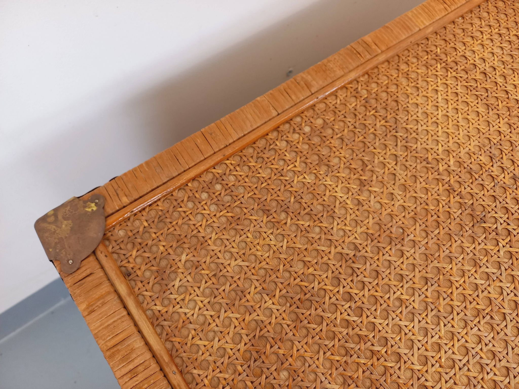 Vintage trunk in wood, rattan, caning, and brass.