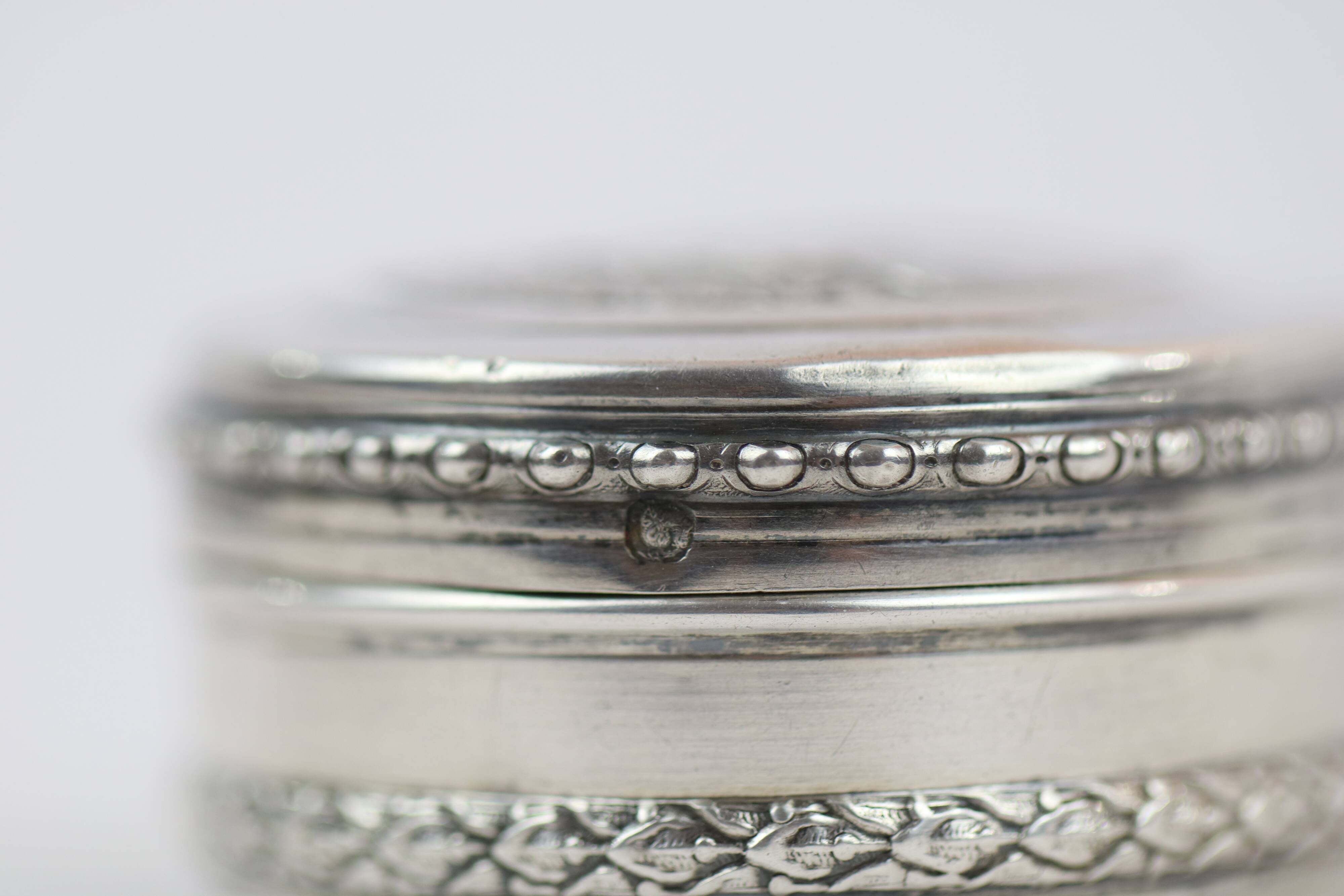 Small round box with silver pills