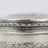 Small round box with silver pills