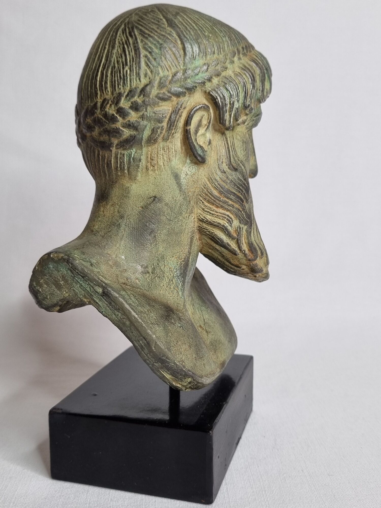 Bust of Poseidon in patinated plaster on wooden base