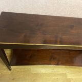 Mahogany console with a golden border.