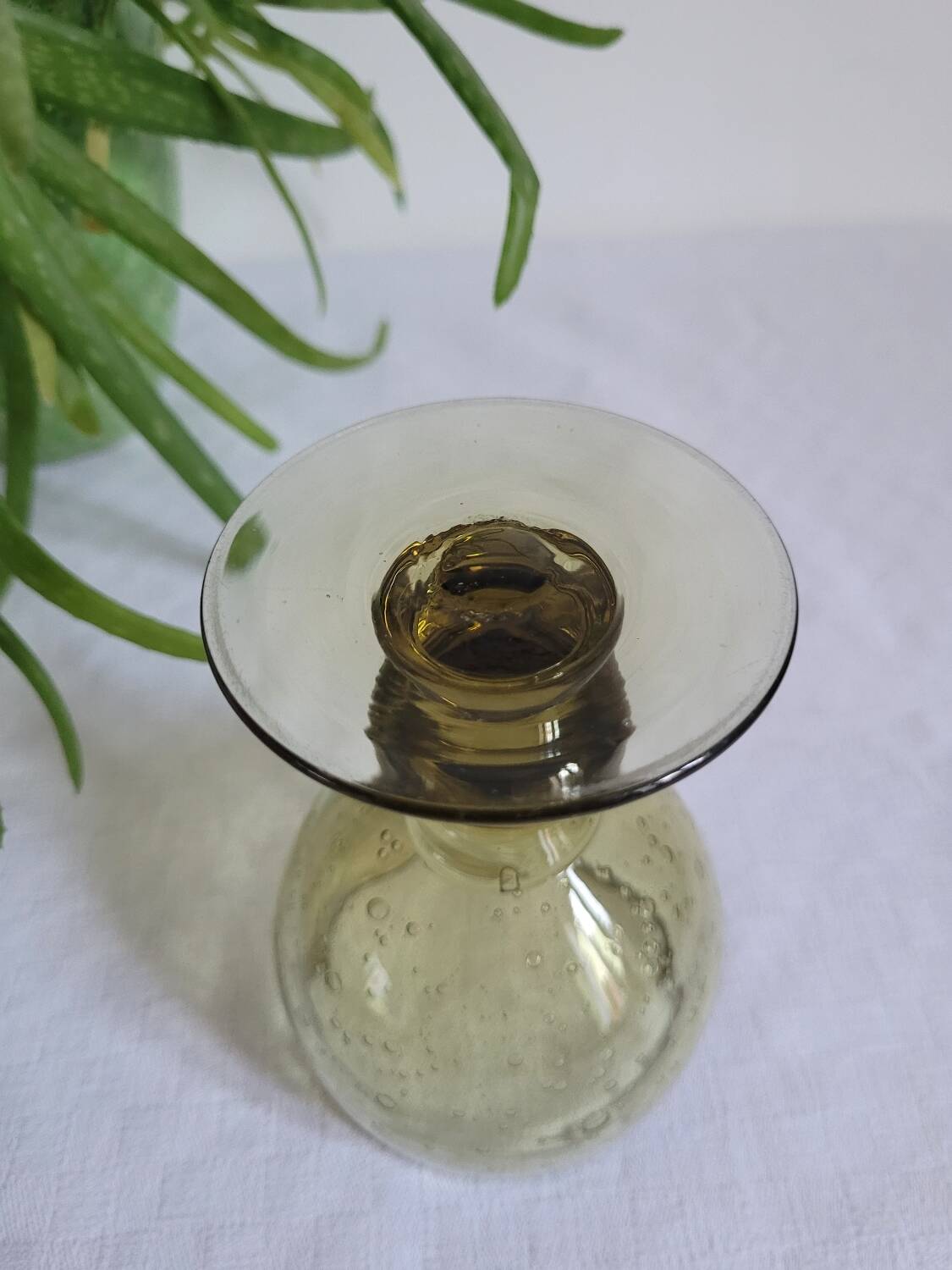 Footed glass made of blown glass