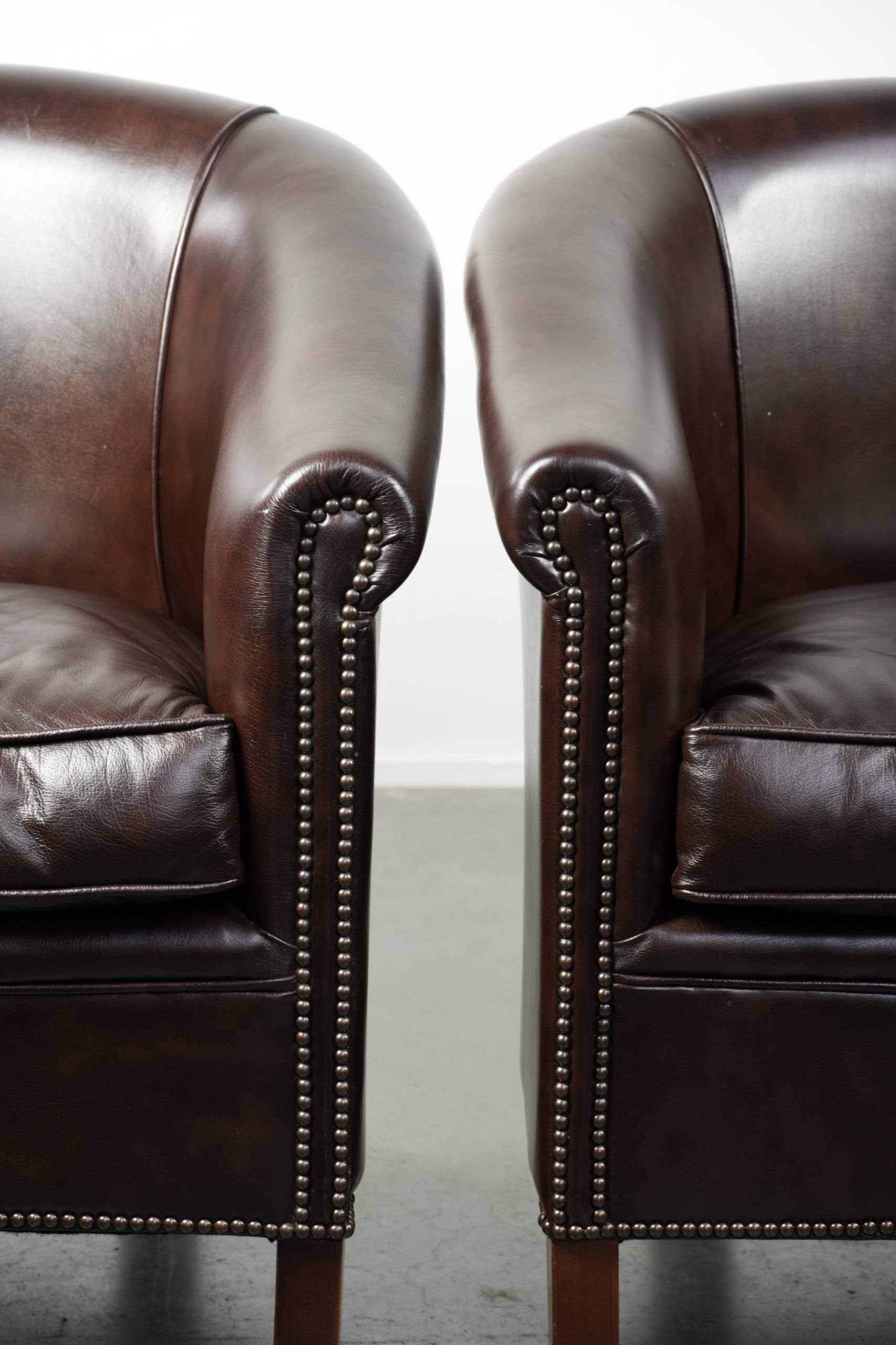 Set of two cowhide club armchairs in good condition with a English design