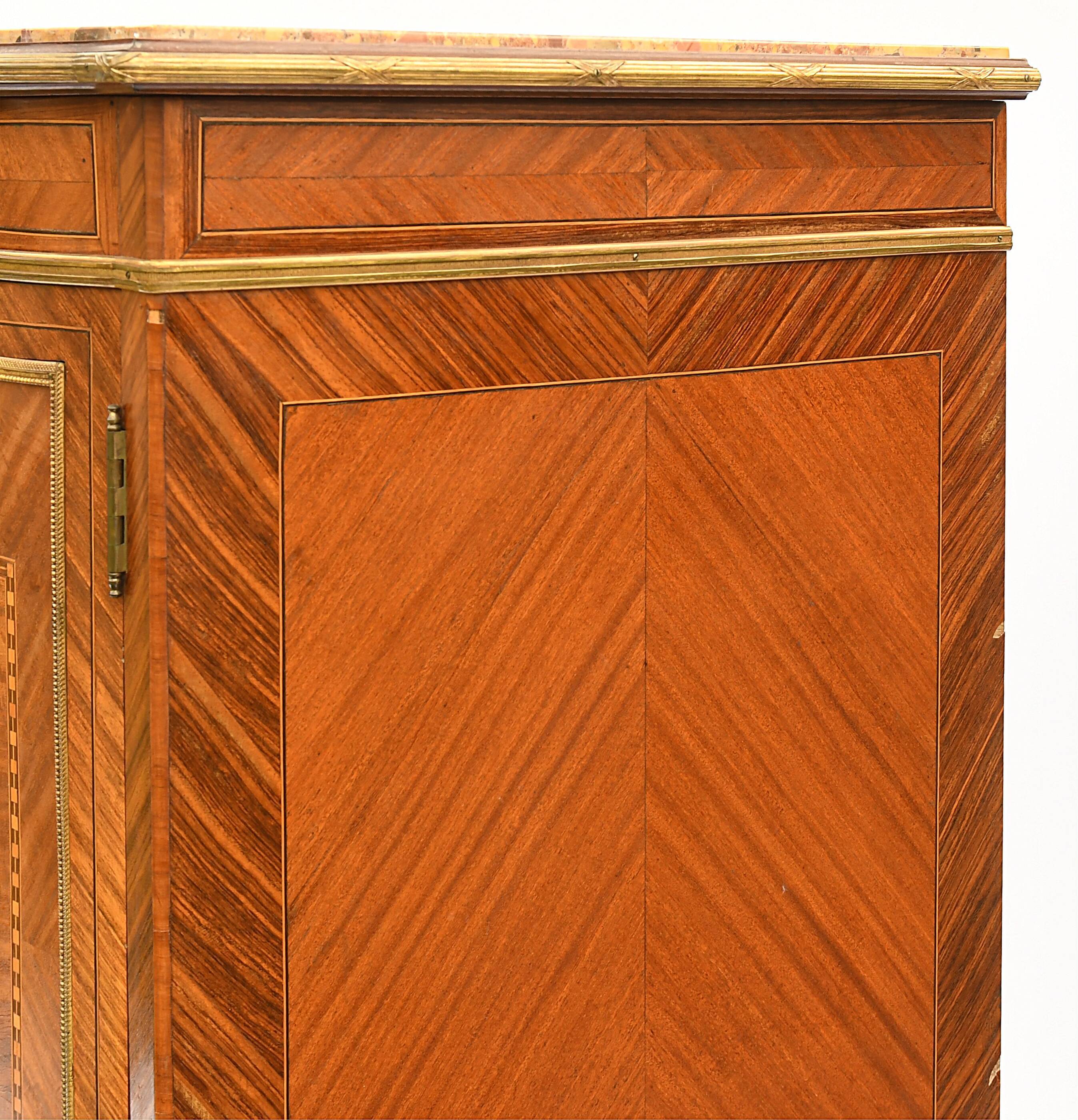In-between furniture in marquetry decorated with a trophy decoration of musical instruments