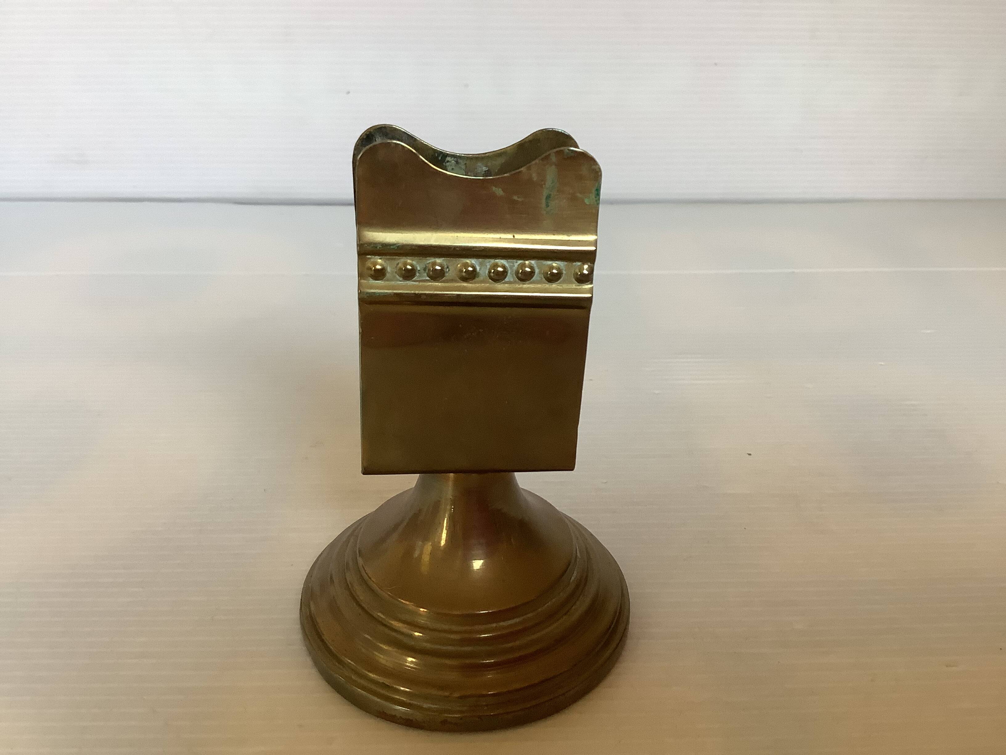 Antique brass match holder with tulip base.