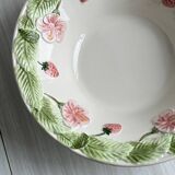 Ceramic slip dish with strawberry and flower pattern.
