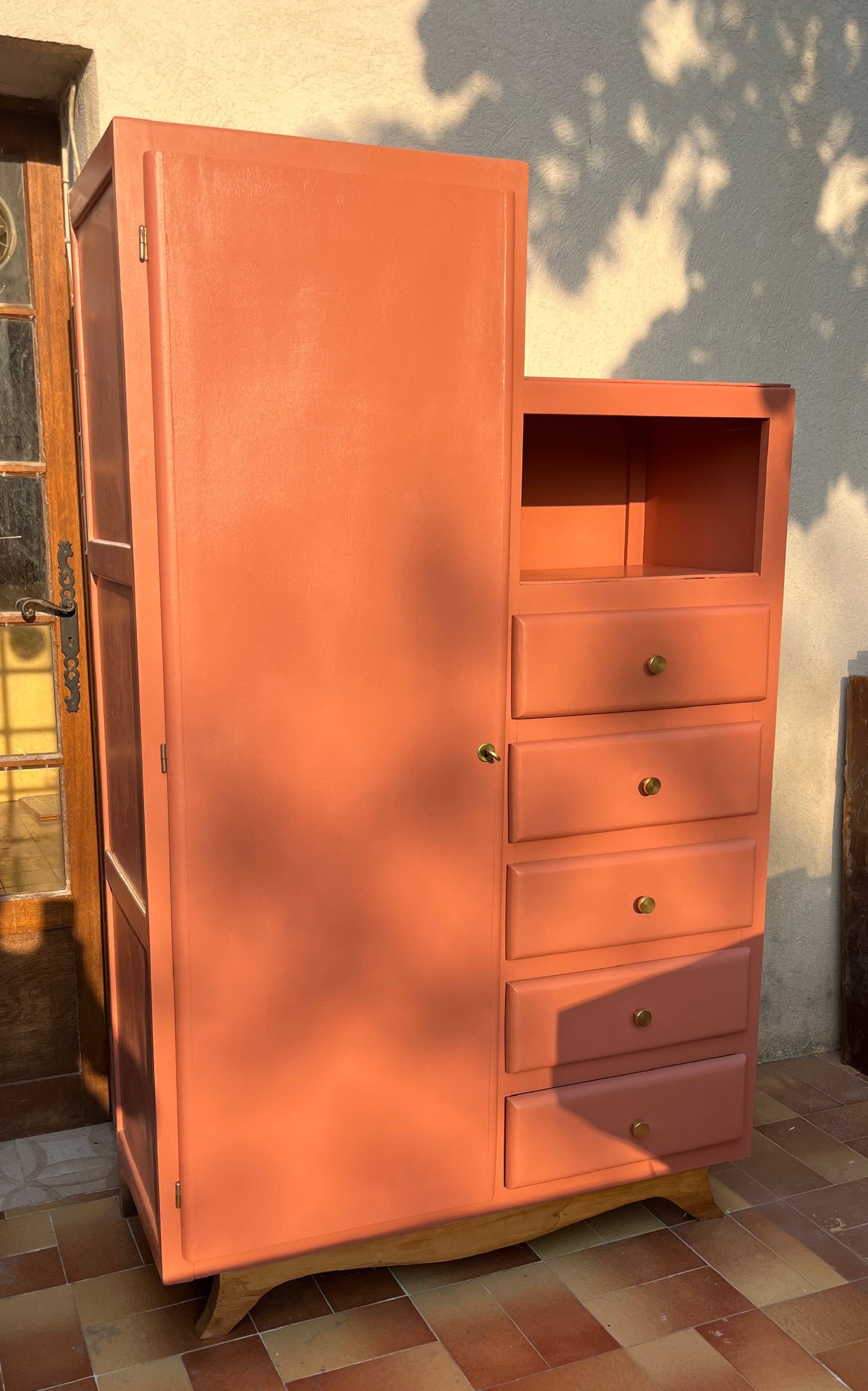 Asymmetrical vintage wardrobe painted in terracotta.