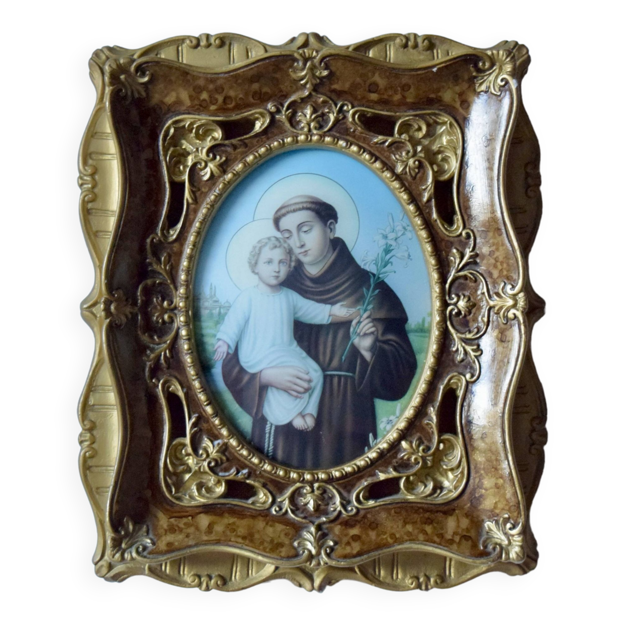 Old religious light frame in gilded stucco and curved glass