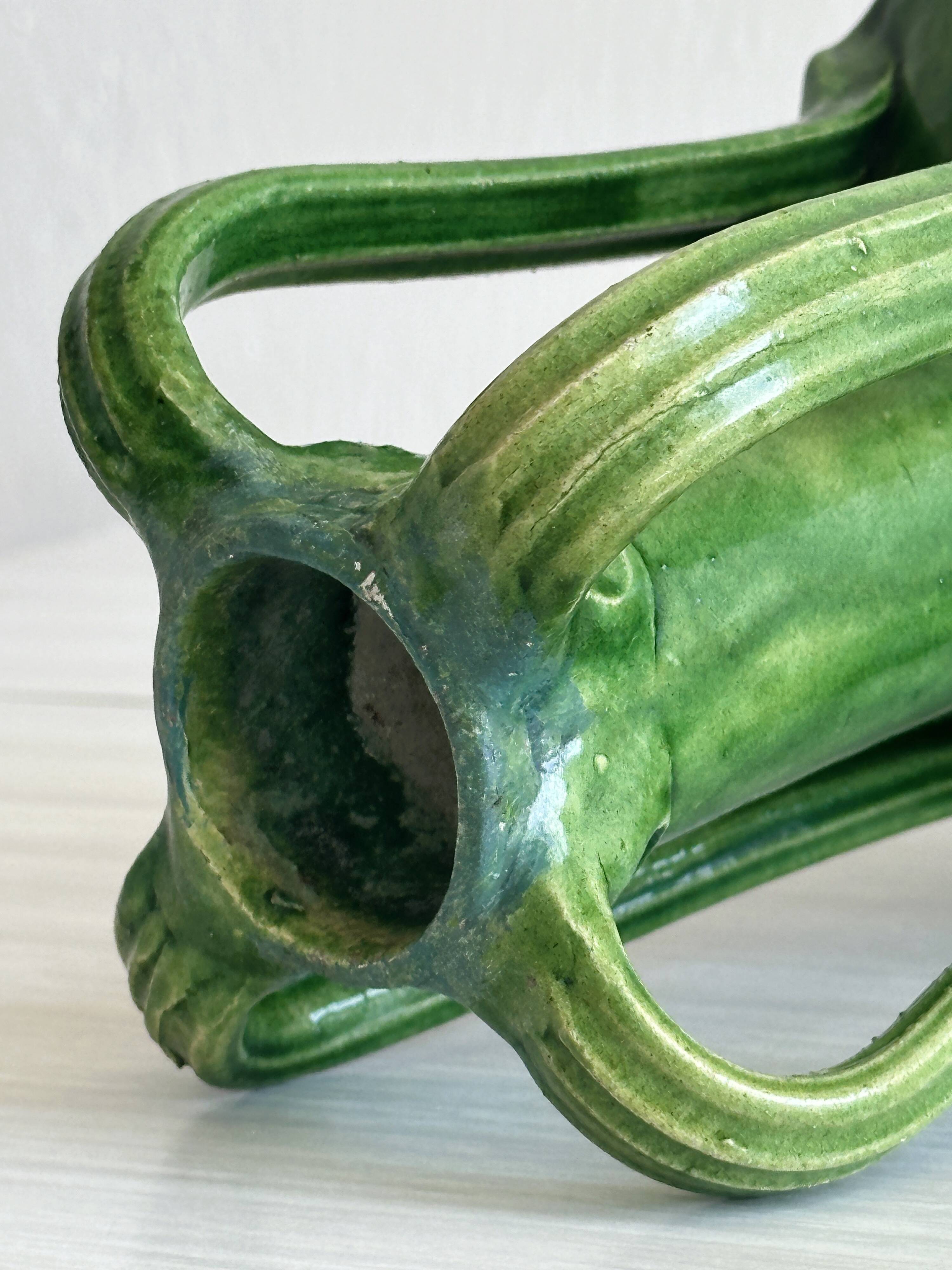 Pottery green ceramic vase with four handles.
