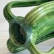 Pottery green ceramic vase with four handles.