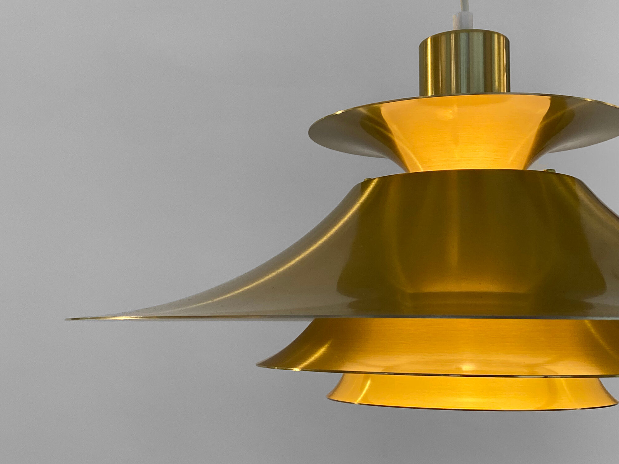 Golden colored aluminum pendant light from Frandsen Lighting. Denmark 1970s