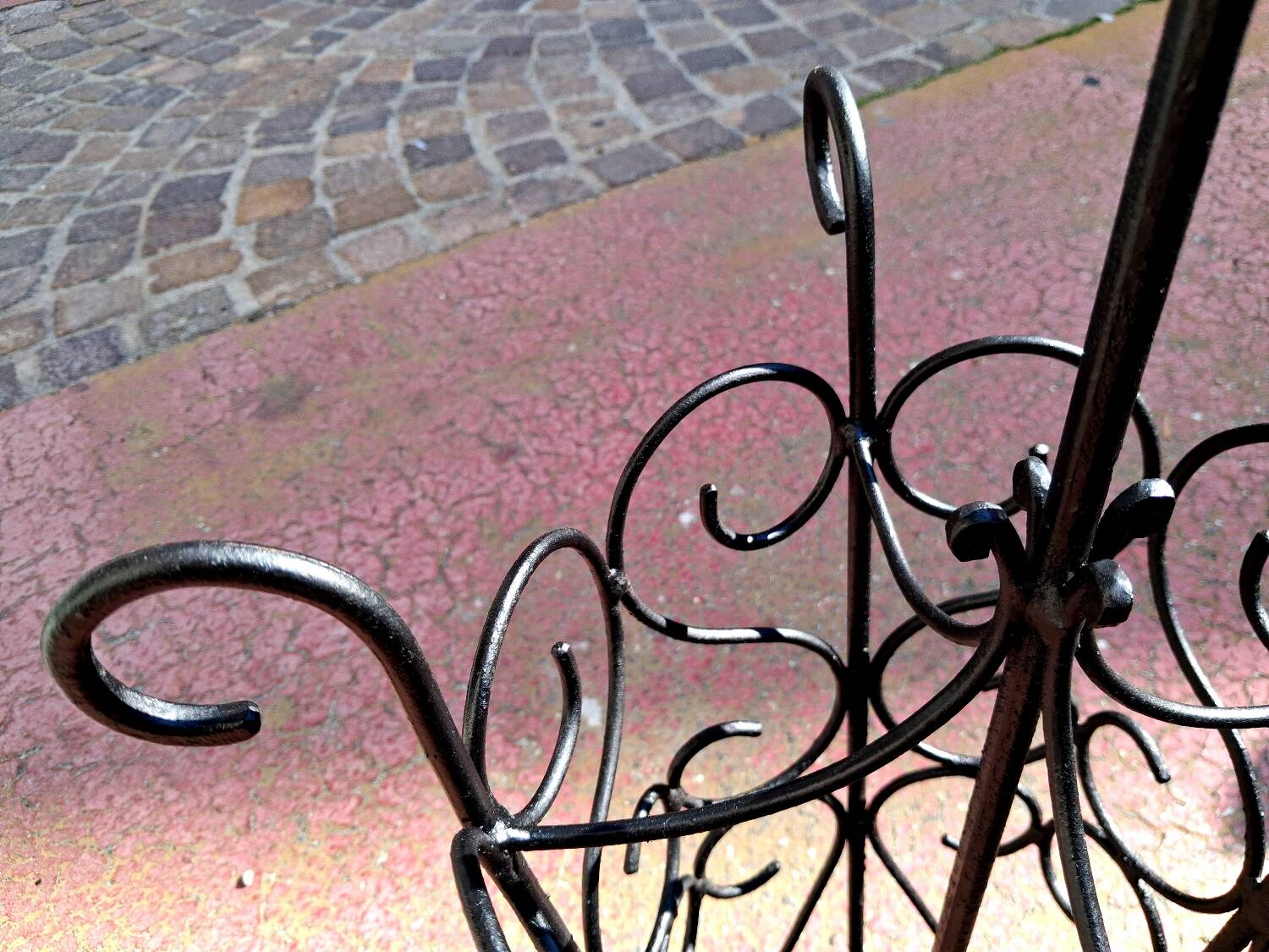 Antique wrought iron umbrella stand for entrance hall, vintage decor.