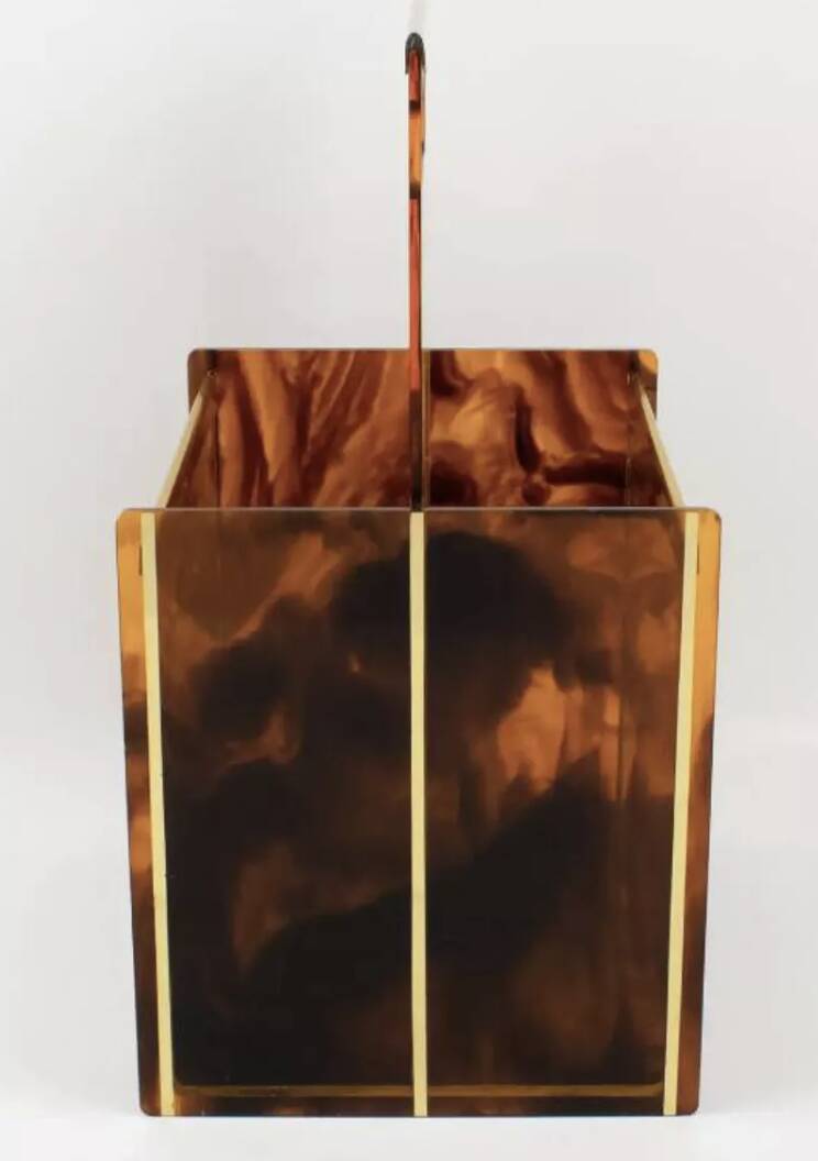 Tortoiseshell lucite magazine rack from the Christian Dior Home collection.