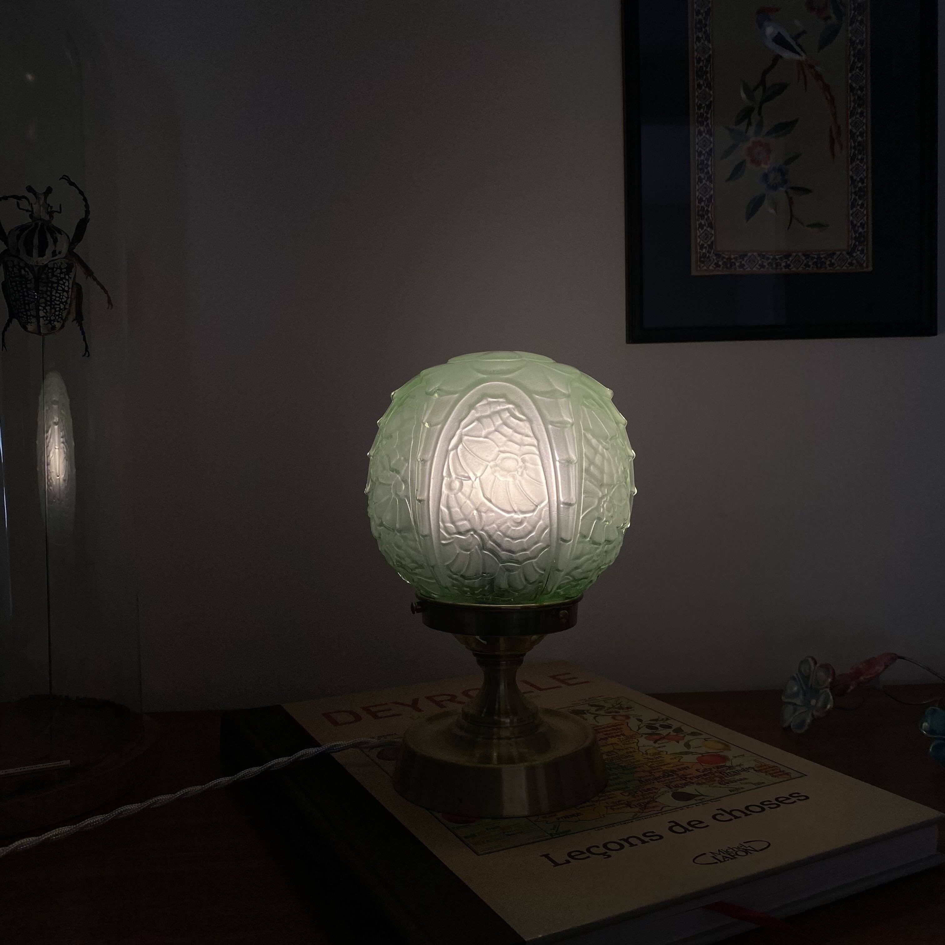 Art Deco green moulded glass globe table lamp with a brass base.