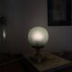 Art Deco green moulded glass globe table lamp with a brass base.