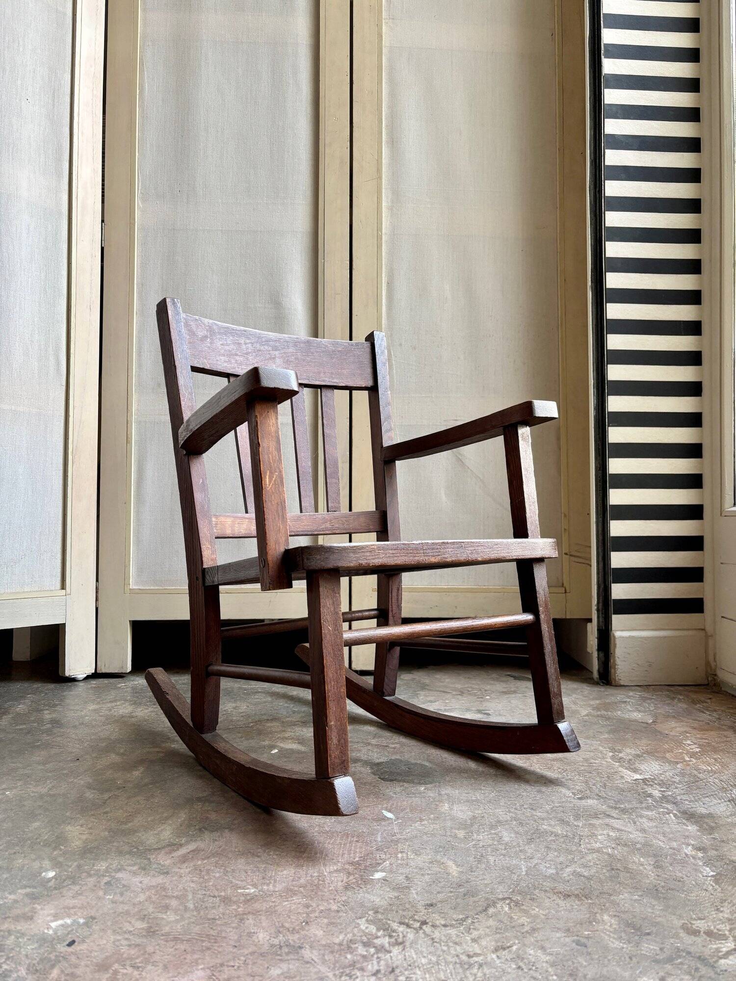 Children's rocking chair in dark wood and cane