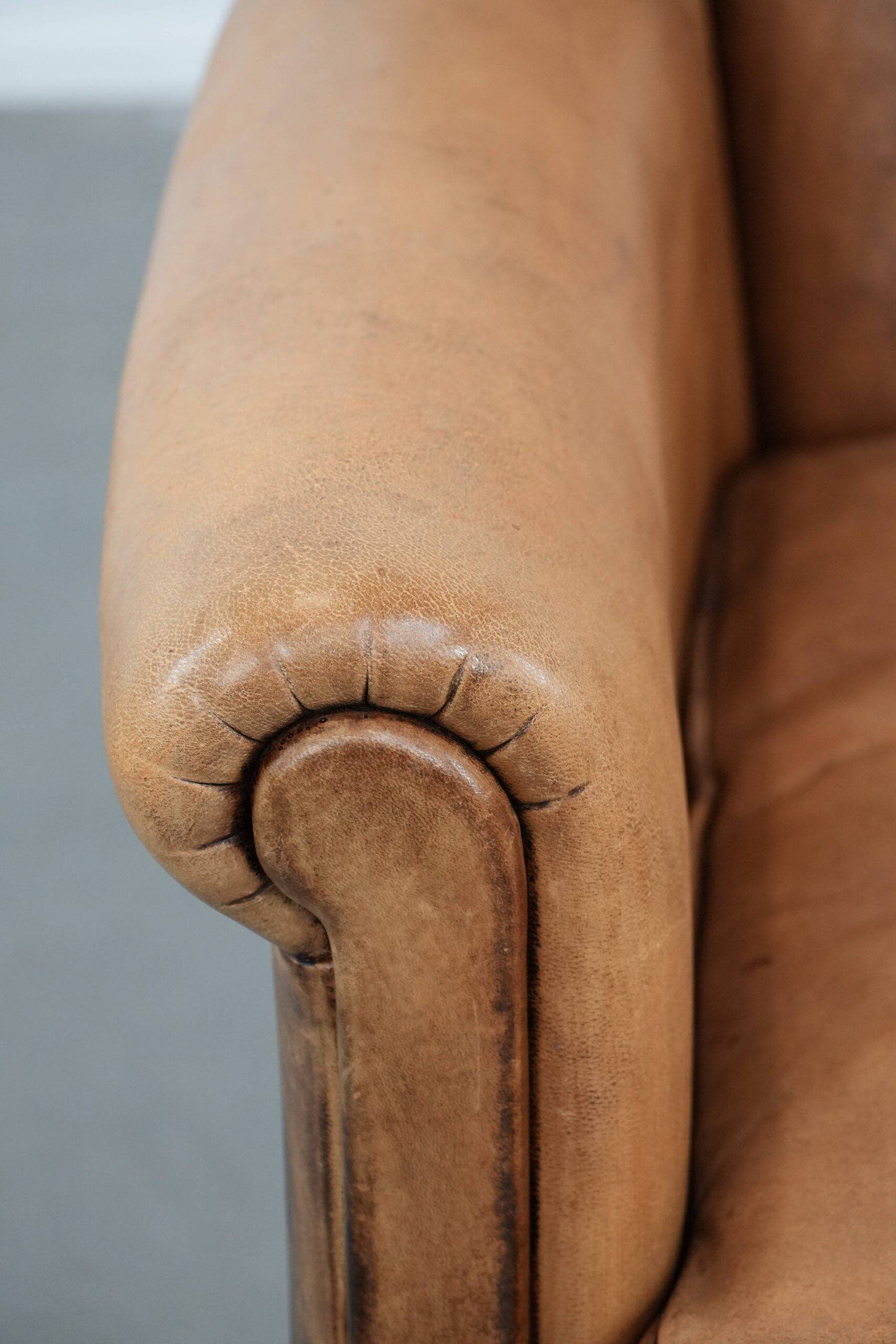 Beautiful subtle vintage sheepskin armchair with elegant legs