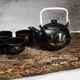 Japanese tea service, teapot and 6 cups, black, gold pattern.