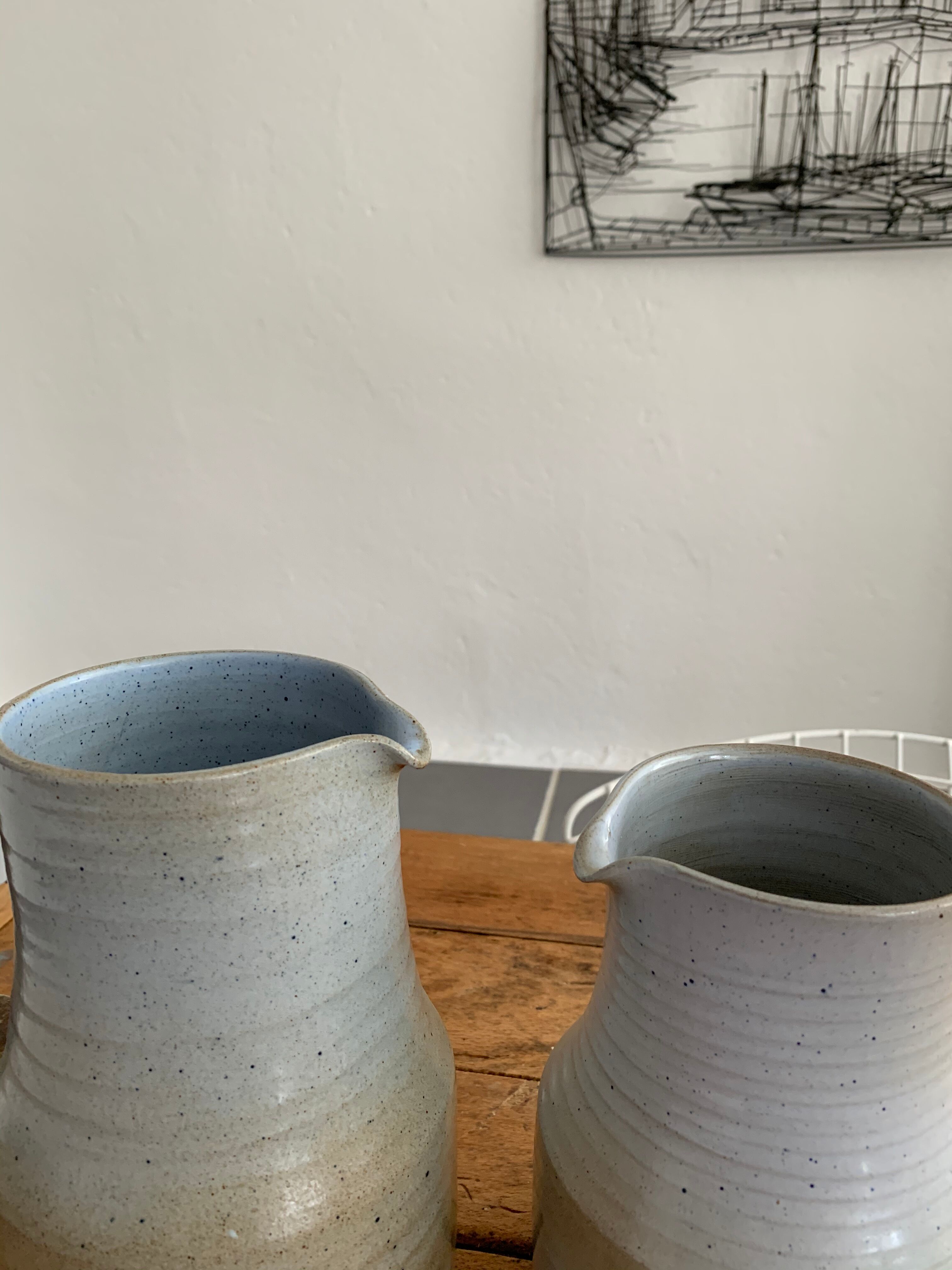 Pair vintage enamelled ceramic pitchers