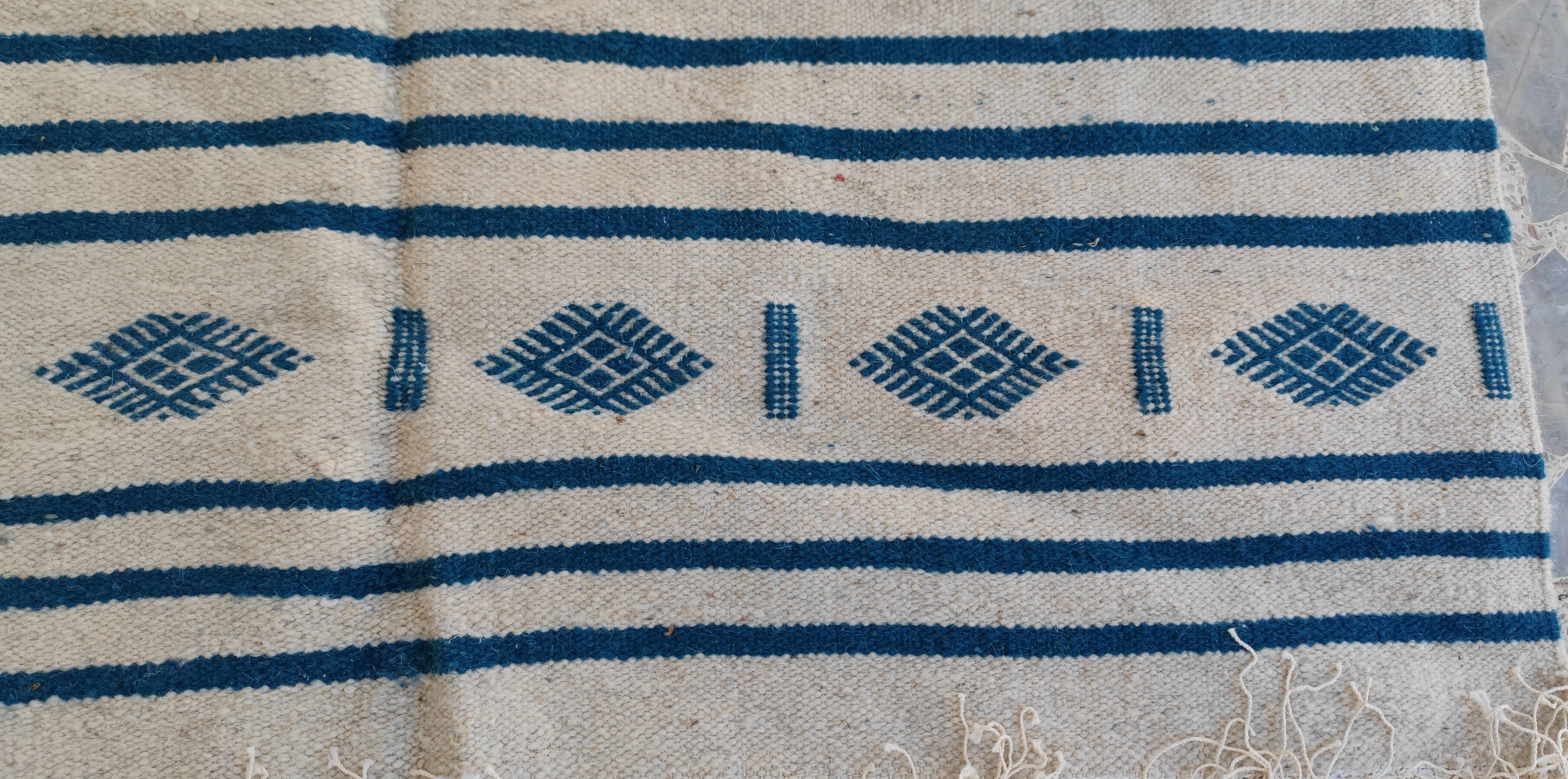 Traditional handmade white and blue kilim rug in natural wool