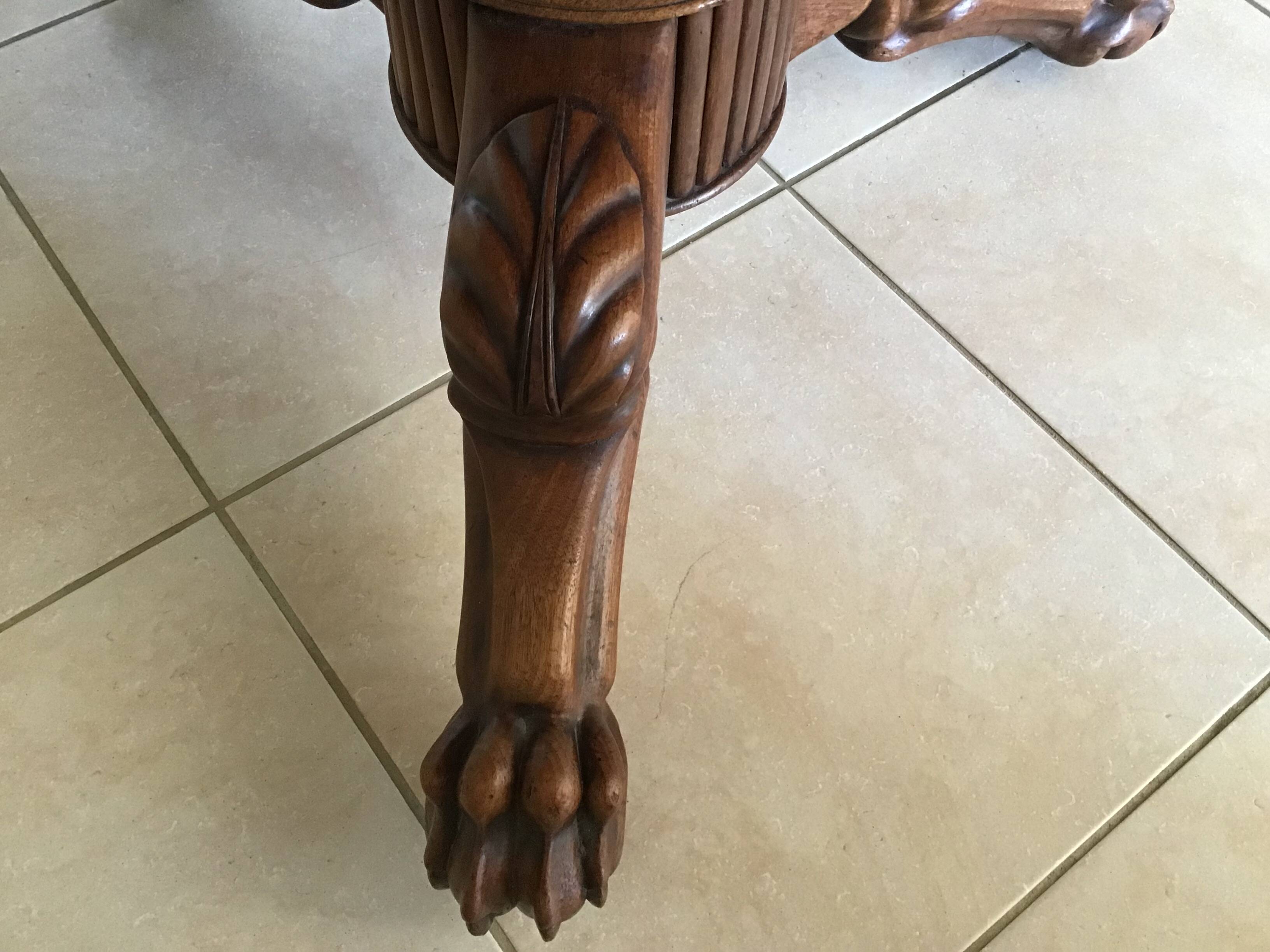 Wooden gueridon with marble, lion paw legs.