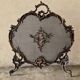 Spark screen, fire screen, bronze fireplace screen decorated with a covered cherub
